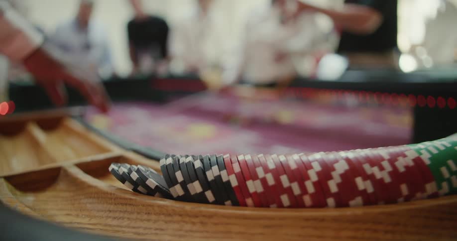Poker chips are lined up around a casino table