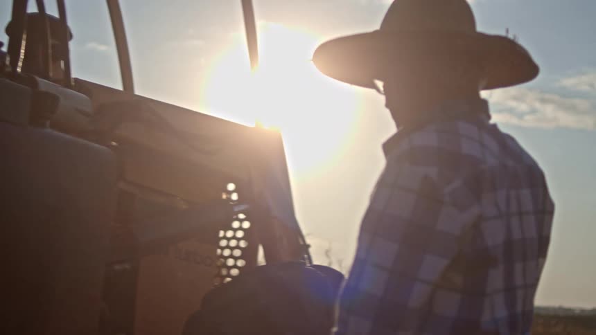 A man checks the engine on the bulldozer