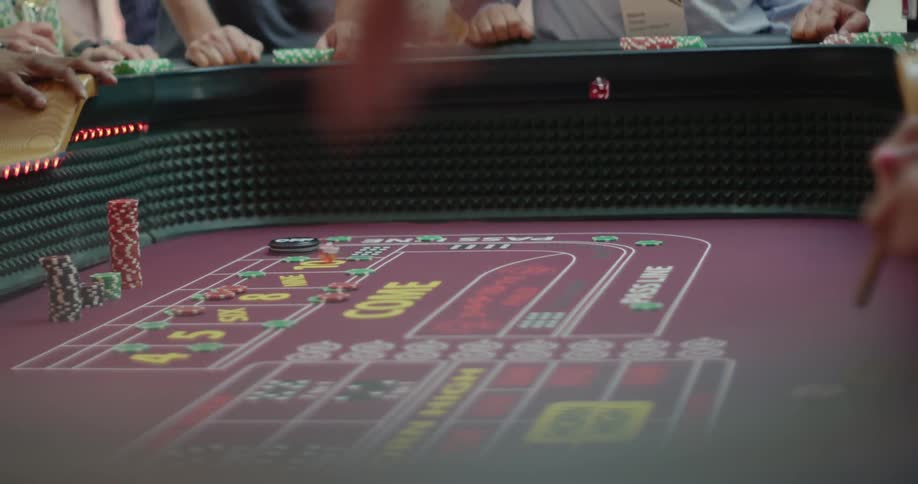 A person throws dice in a casino