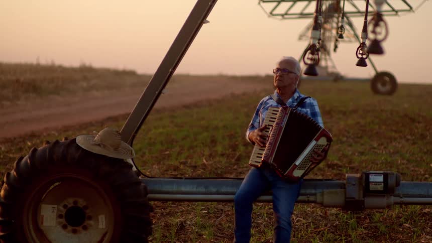 A man plays an accordion outside