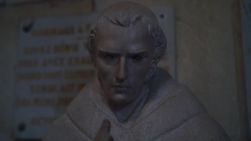 A statue near some signs