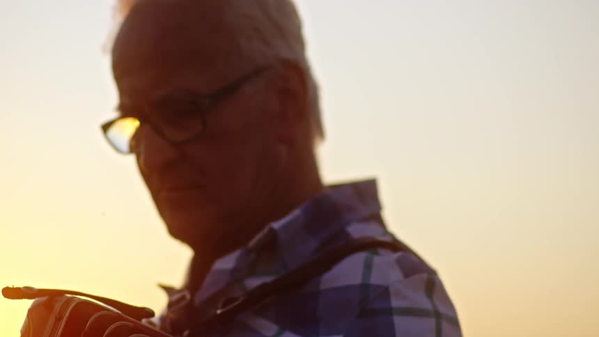 The man is concentrating while playing the accordion