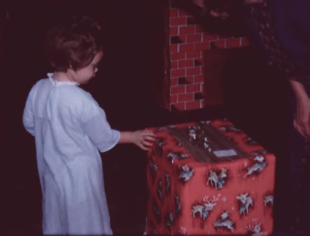A woman and child open a present