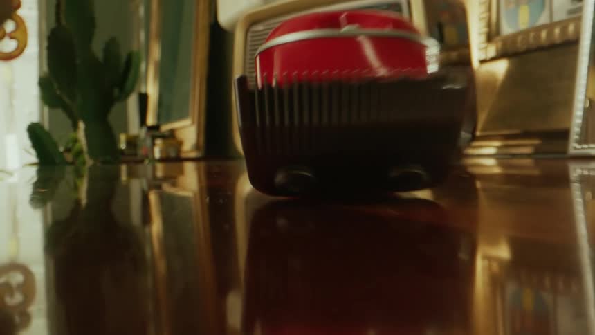 The barber lifts the red razor