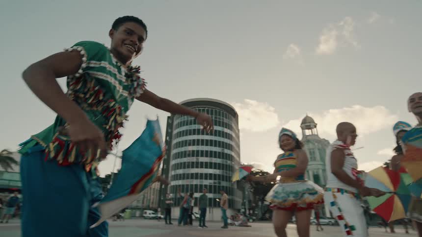The dances jump high and smile as they perform