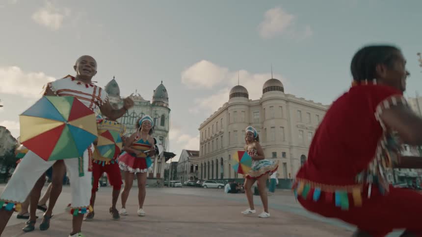 The dancers are performing and jumping all around in the city