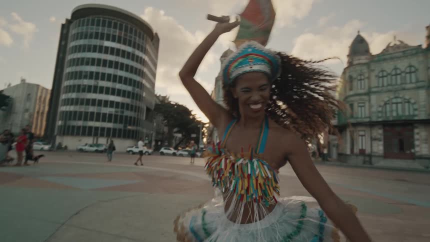 Woman dancing in typical clothing and happy