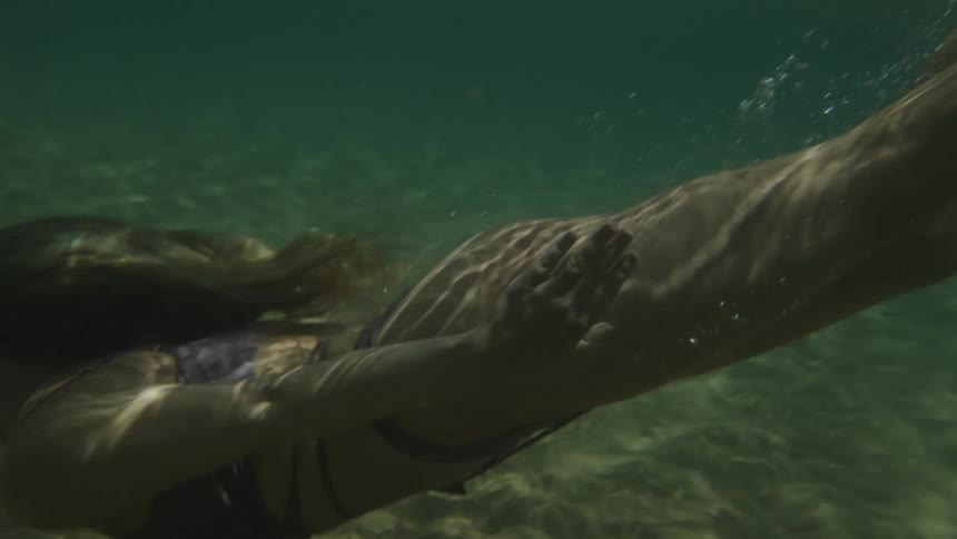 Blonde woman diving into the crystal clear waters of the sea