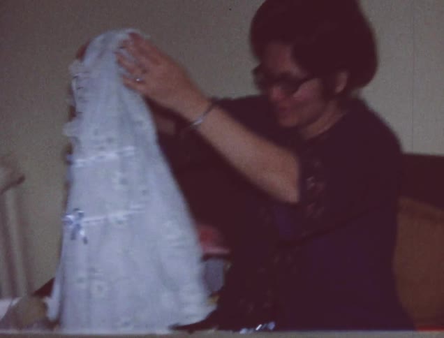A woman looks through some gifts