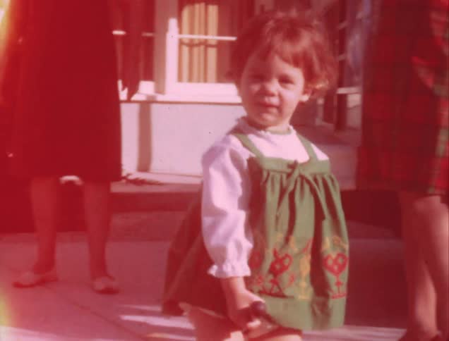 A child walks past some people