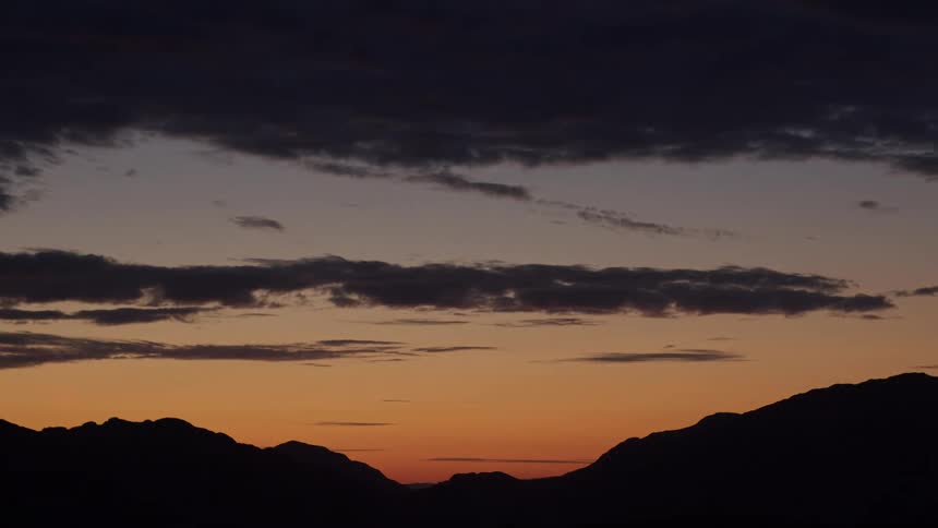 The sun sets on the mountains