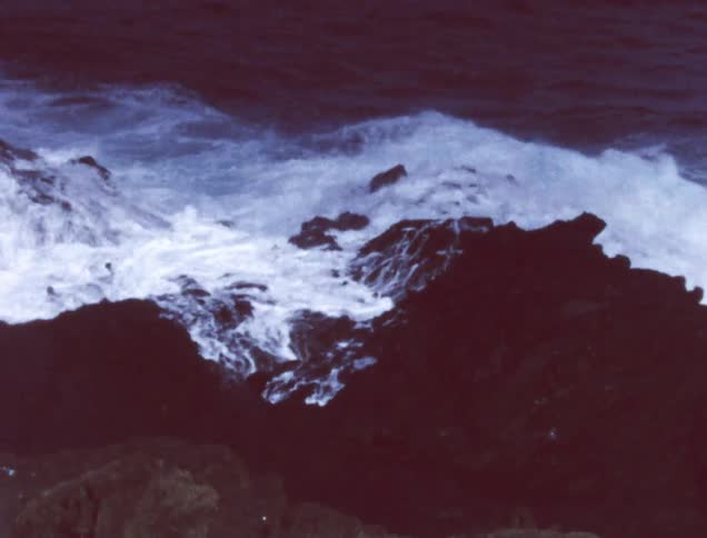 Waves crash against the rocky shore