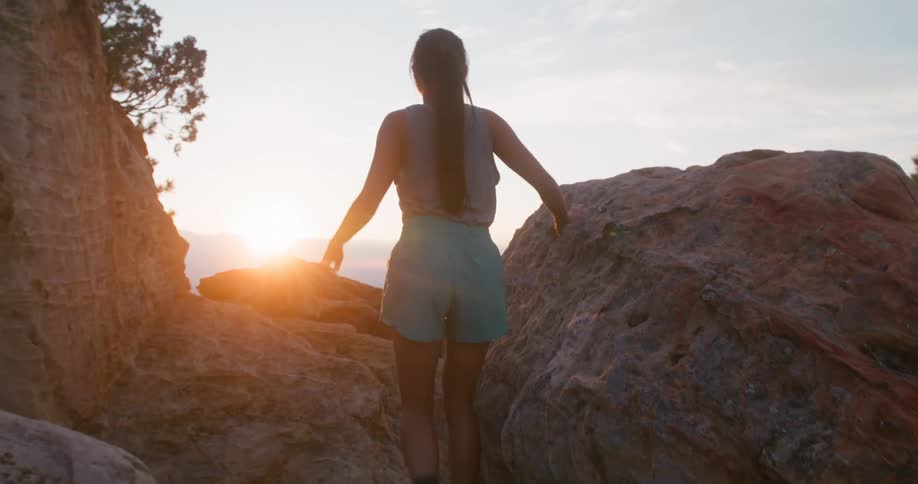 Woman takes an uphill jog through the mountains