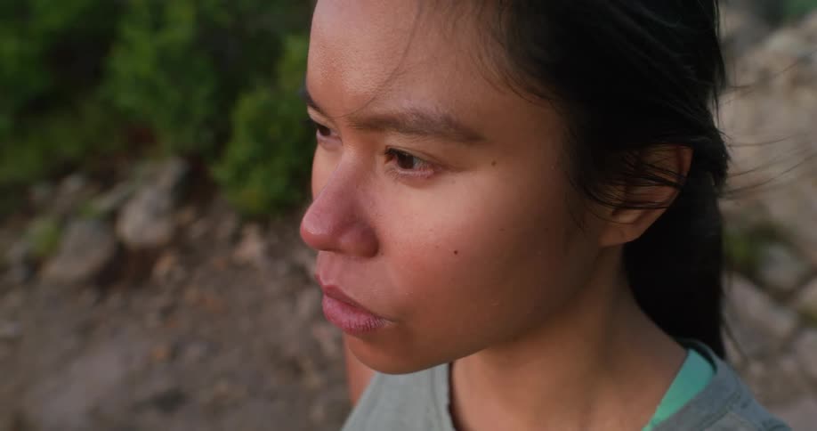 A woman closes her eyes and takes a deep breath