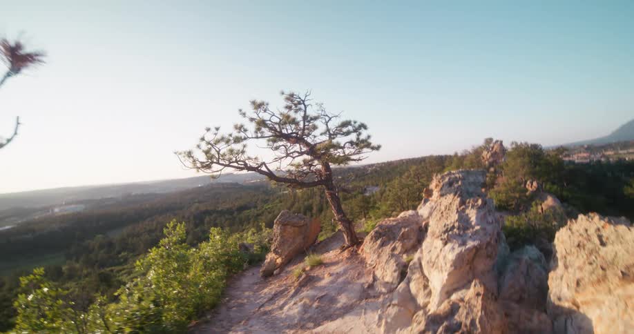 Past the cliff is a long green landscape