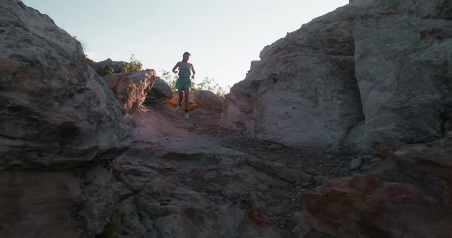 Woman running on a trail in the mountains