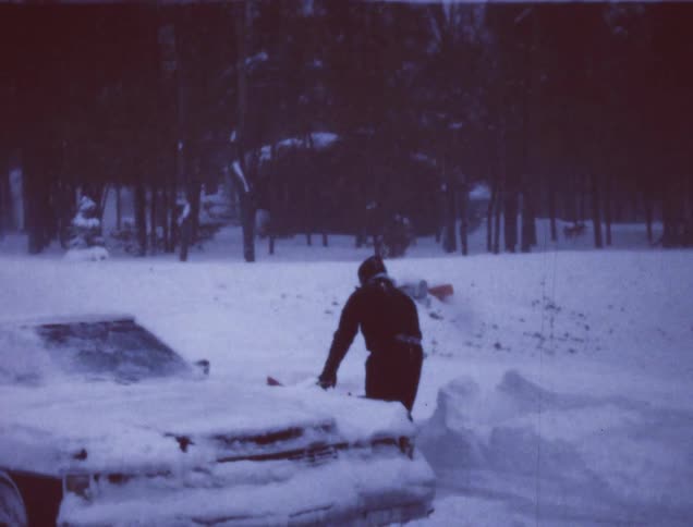 A man is using a snow blower