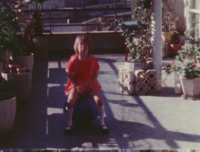 A child is bouncing on a ball