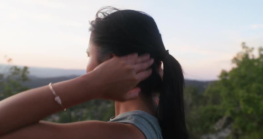 Woman stretches outdoors in a natural setting
