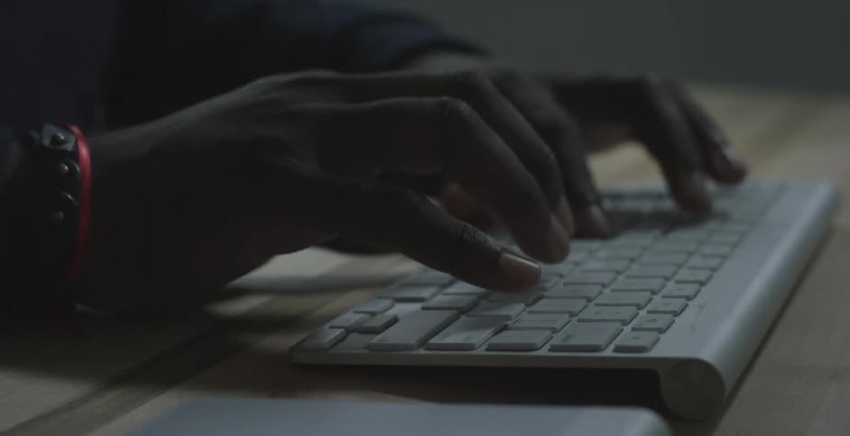 Hands type on a keyboard