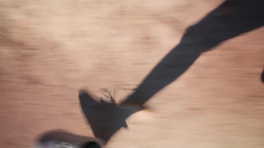 The woman is racing on the thin trail on a sunny day