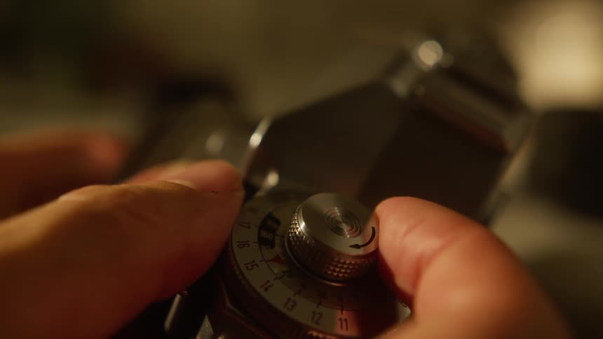 Fingers manually adjusting a device