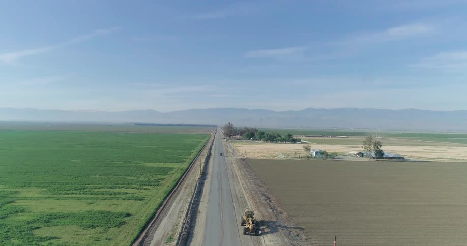 Aerial view of a highway in the middle of agricultural fields