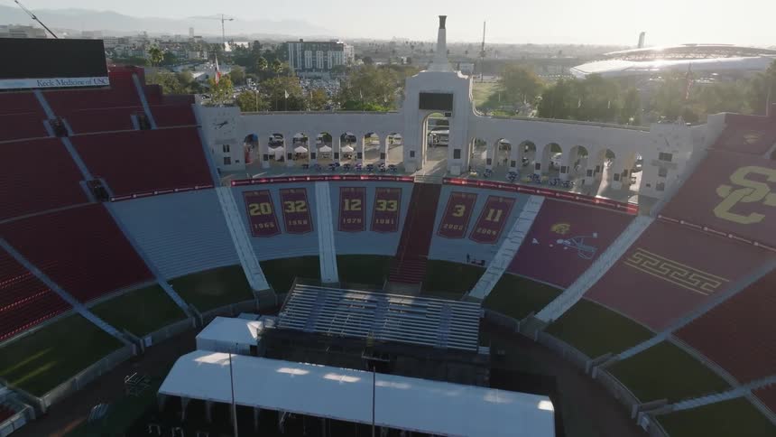 Aerial view of the Los Angeles Memorial Coliseum  and its surrounding area in a city setting