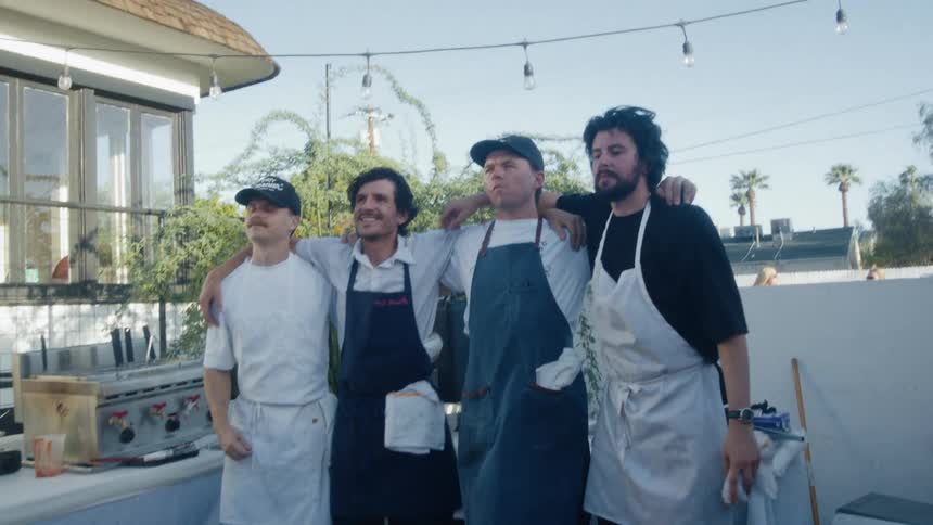 A group of chefs stand together for a photo