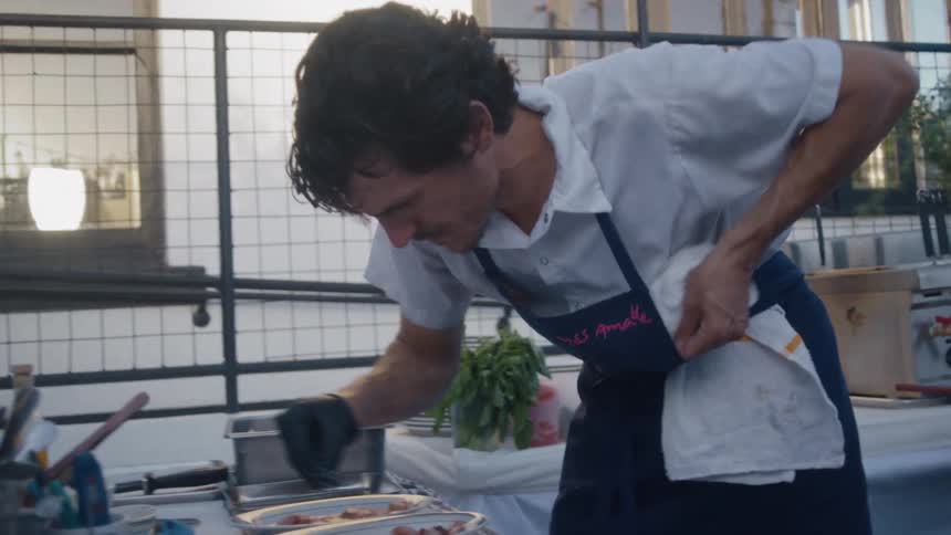 Men in an outdoor kitchen preparing dishes