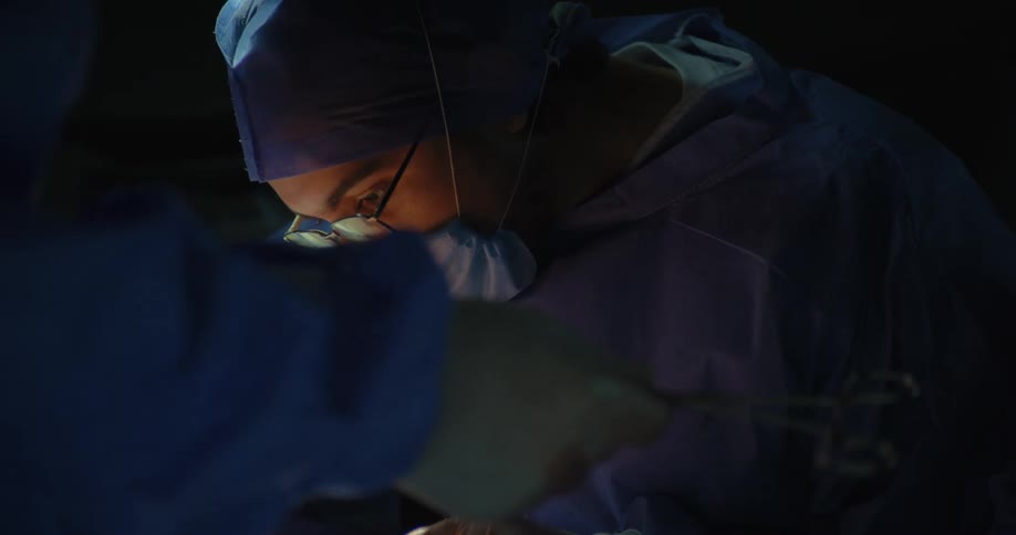 Female surgeon with a team performing surgery