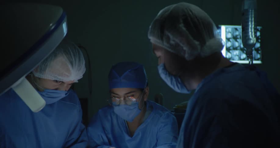 The surgeon is handed tools during surgery