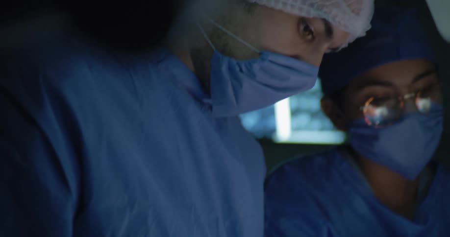 Two doctors concentrated in an operating room