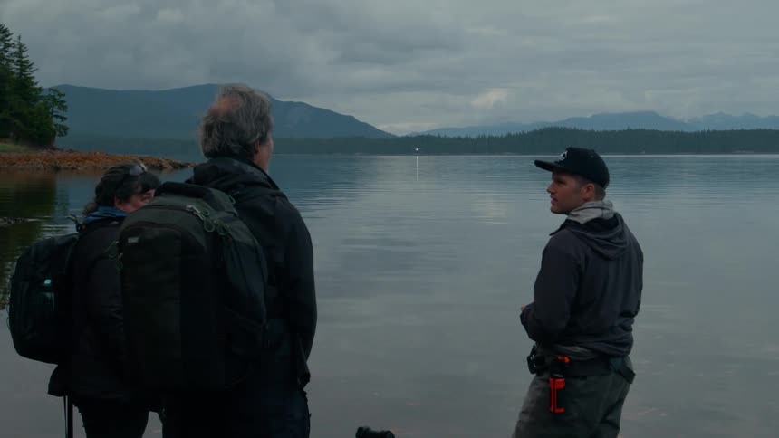 Hikers talk together by the lake