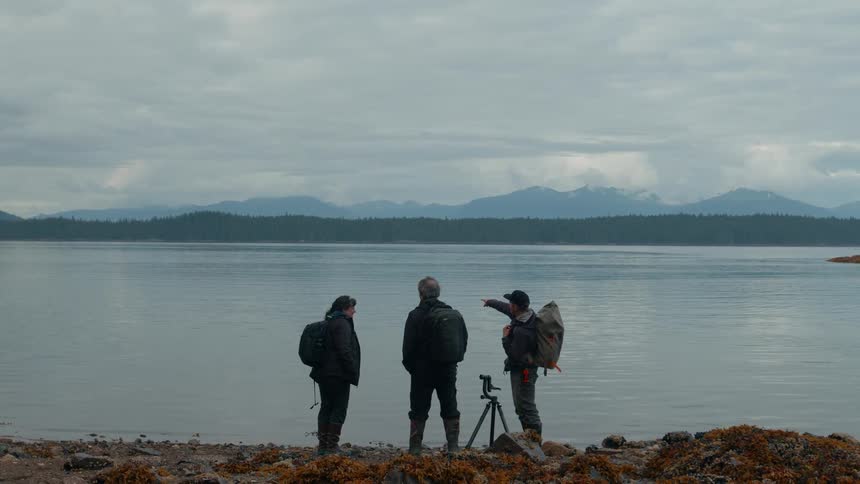 A man points out over the water