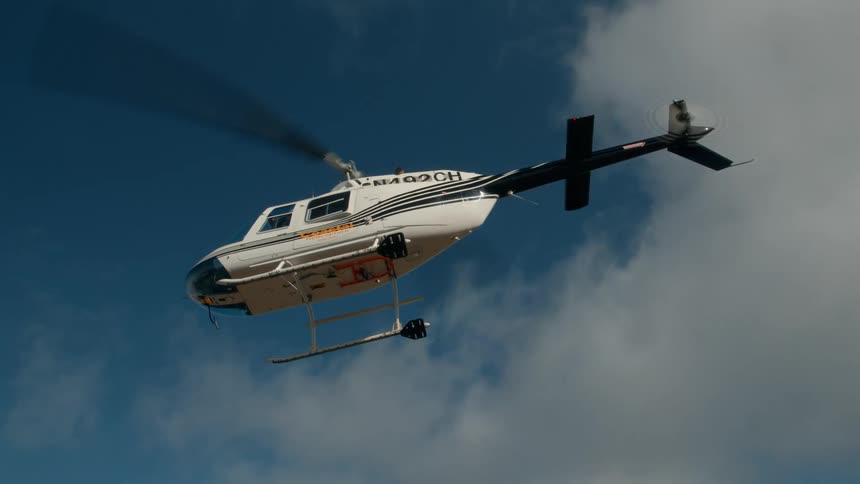 Helicopter taking off from a mountain