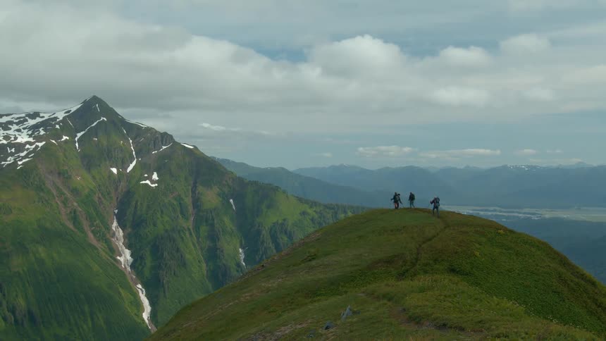 Panorama of mountains and people hiking in the background