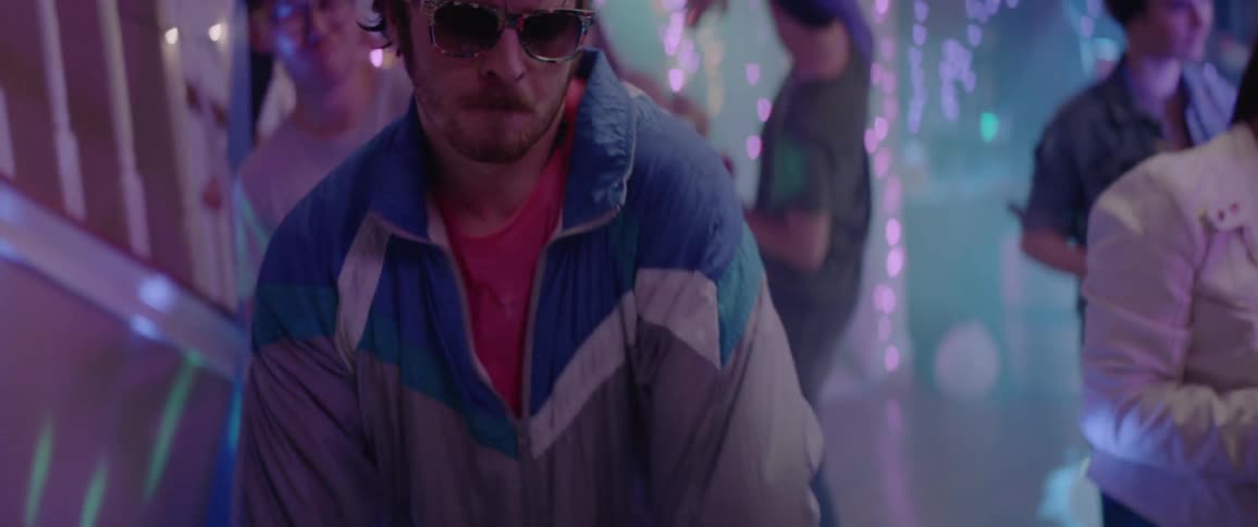 A man is dancing wearing sunglasses