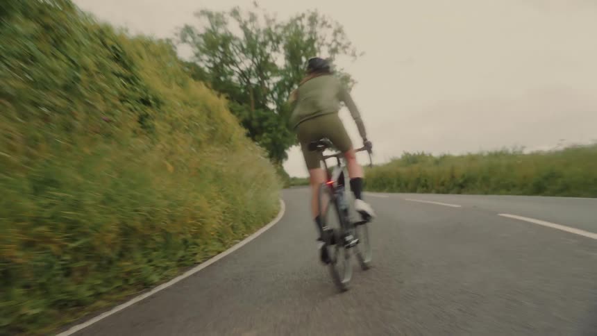 A man bikes on the road