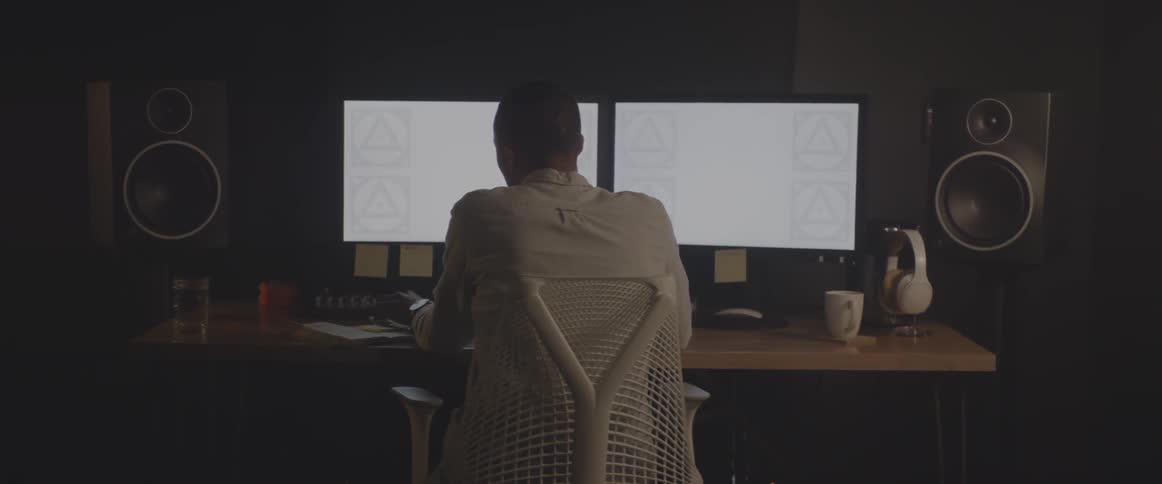 A man sits down in front of a computer