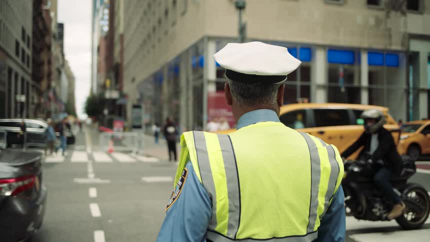 Traffic police officer on an urban road with vehicle traffic