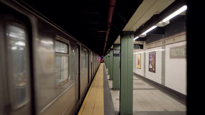 A subway train leaves the platform at rector street station in new york city