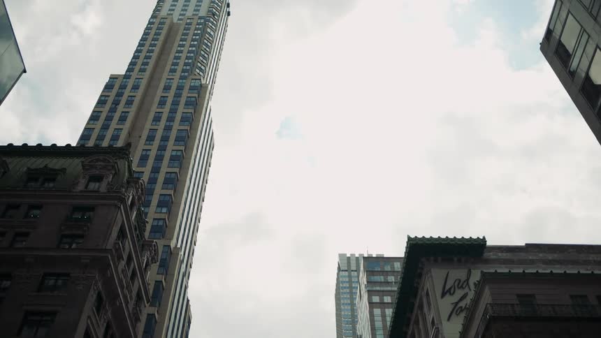 A cloudy sky is above the towers