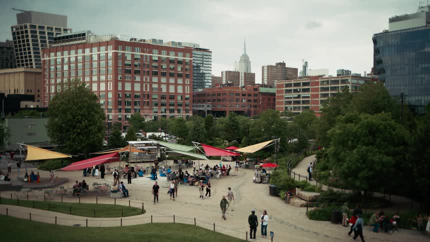 People having fun in a park and a city in the background