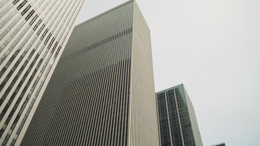 Upward view of modern skyscrapers against a cloudy sky