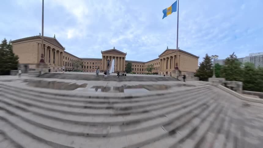 A square with a monument of a person riding a horse and further ahead another square with a fountain with water splashing upwards
