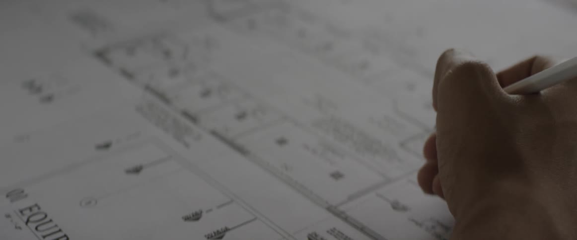 A man marks blueprints