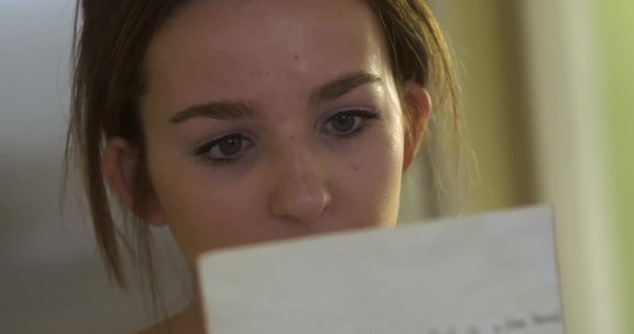 A girls reads a piece of paper