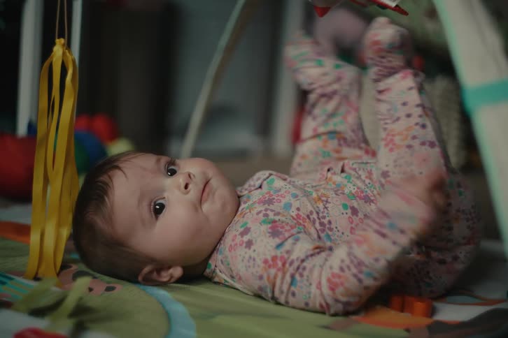 Baby lying on the carpet playing