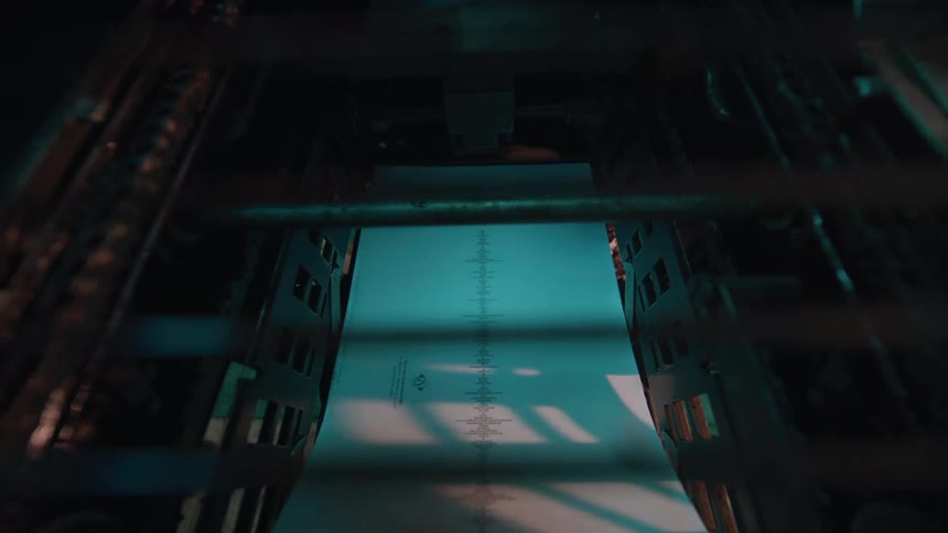 Large automatic printer pulls sheets of paper between metal cylinders
